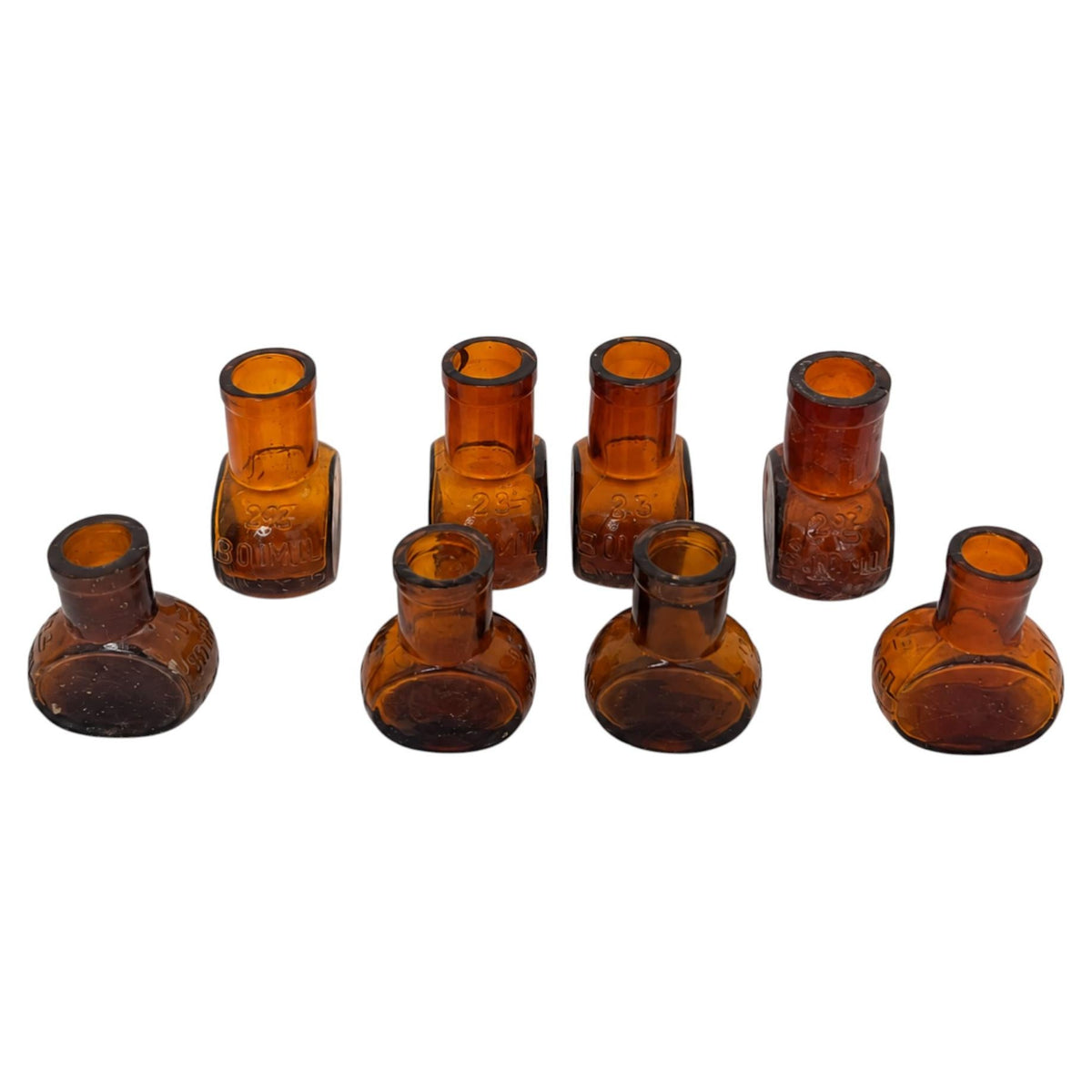 Collection of 8 Antique Bovril Amber Glass Bottles