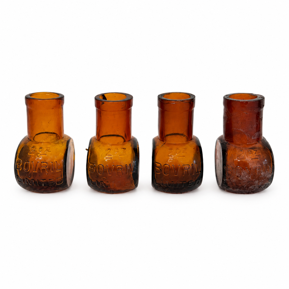 Collection of 8 Antique Bovril Amber Glass Bottles