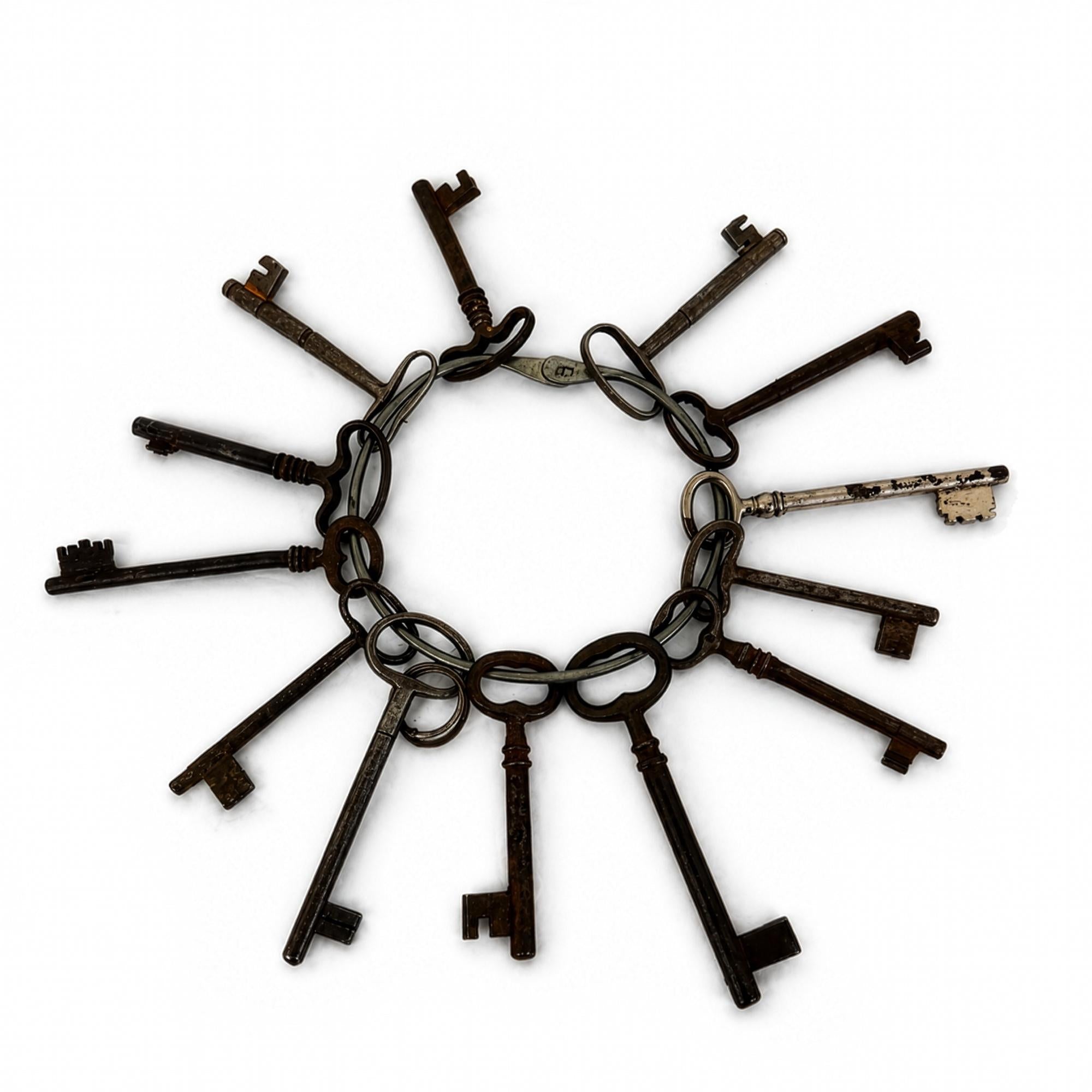 Set of 13 Antique Iron Skeleton Keys on Keeper's Ring, circa 1900