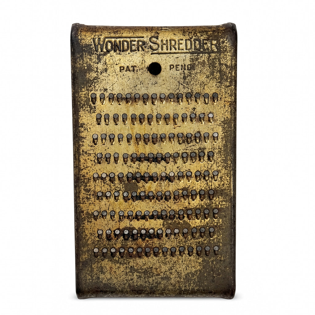 Wall Installation of Thirteen Antique and Vintage Metal Kitchen Graters
