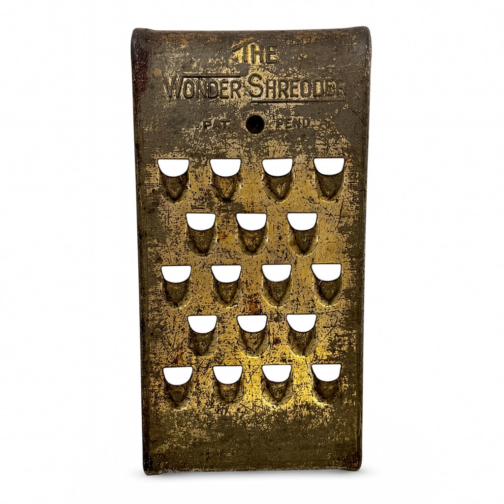 Wall Installation of Thirteen Antique and Vintage Metal Kitchen Graters