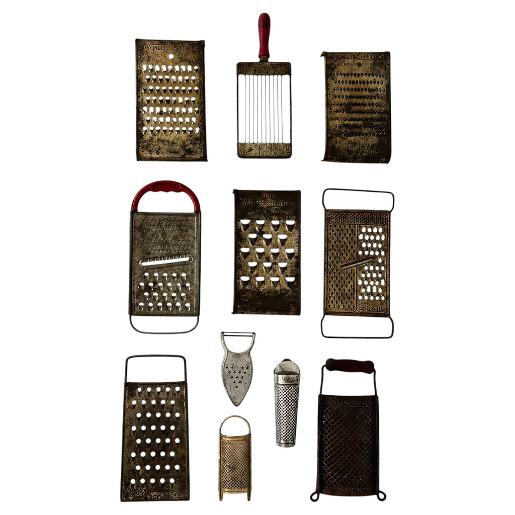 Wall Installation of Eleven Antique and Vintage Metal Kitchen Graters